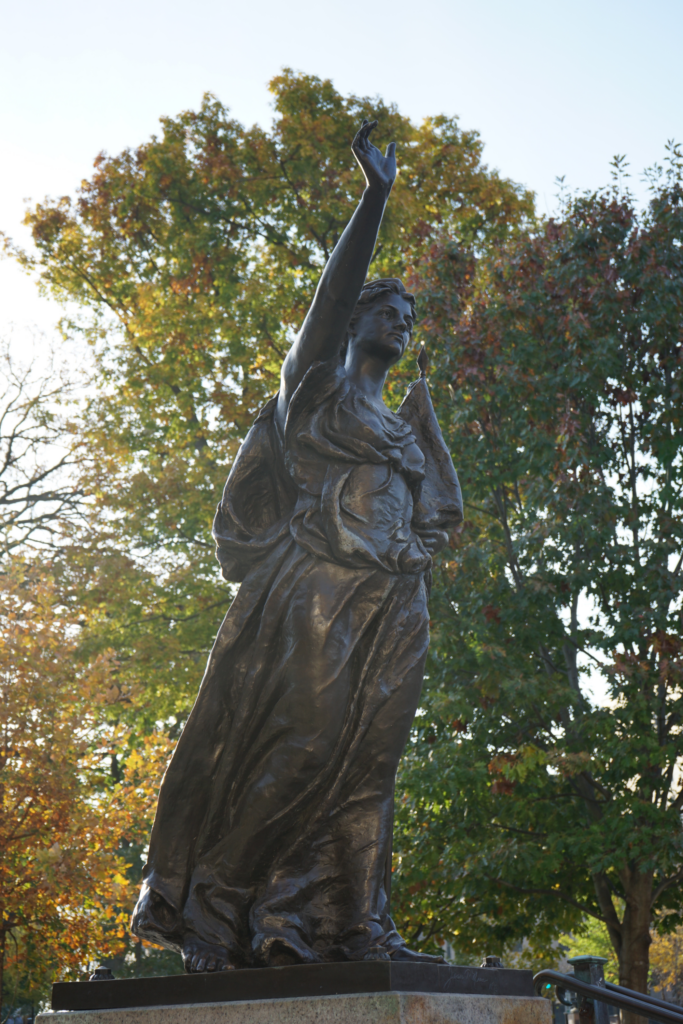 Wisconsin’s Lady Forward in front of various yellow and green leafs.